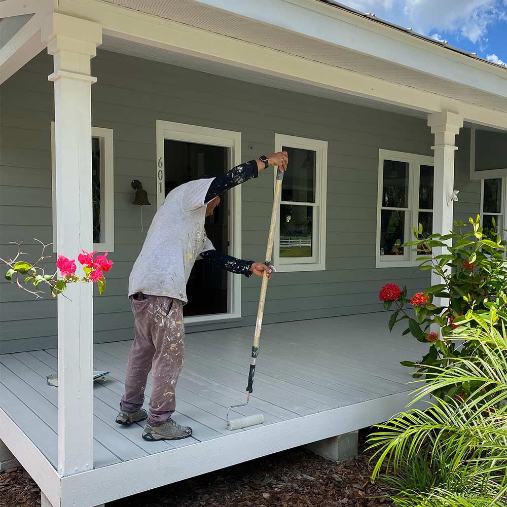Man painting porch