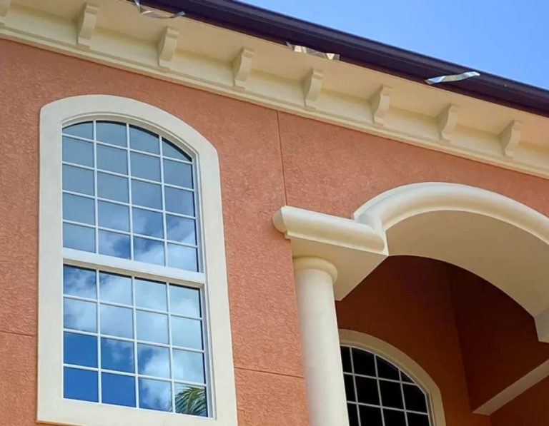 Professionally painted exterior home in Sarasota Florida with terracotta stucco walls and cream architectural trim