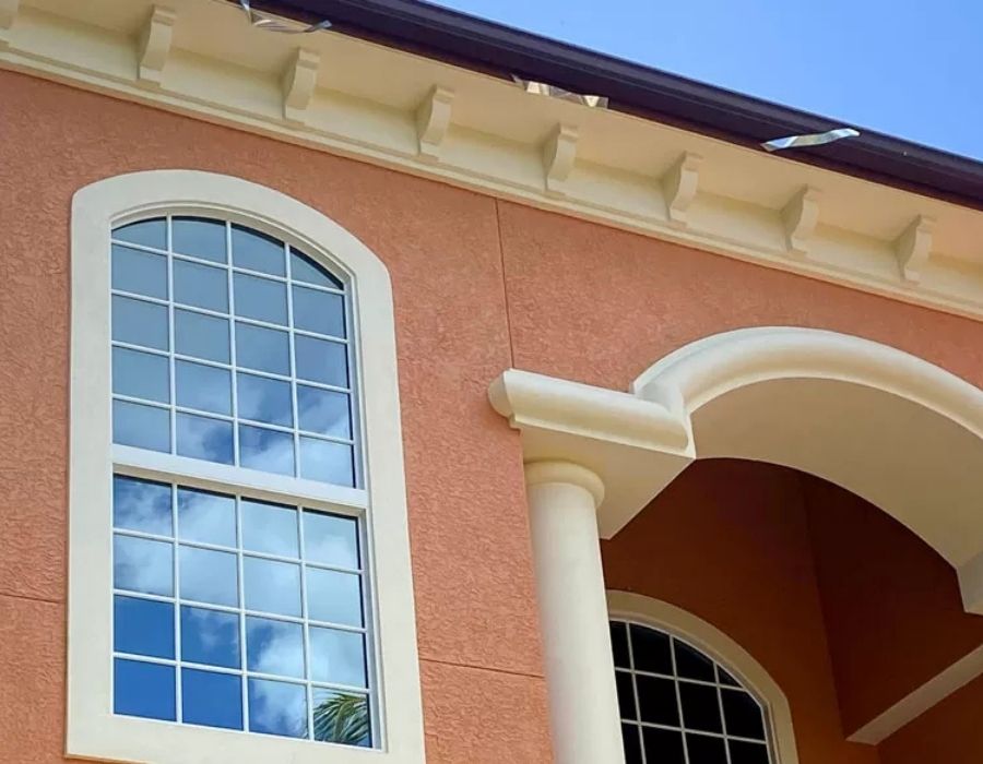 Professionally painted exterior home in Sarasota Florida with terracotta stucco walls and cream architectural trim