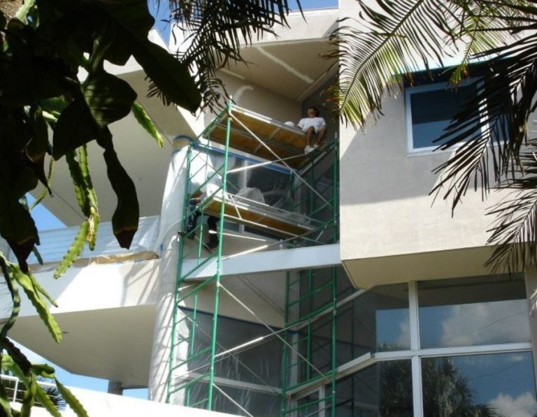 Ultimate Services Co. painting crew on scaffolding completing a multi-story exterior painting project in Sarasota Florida