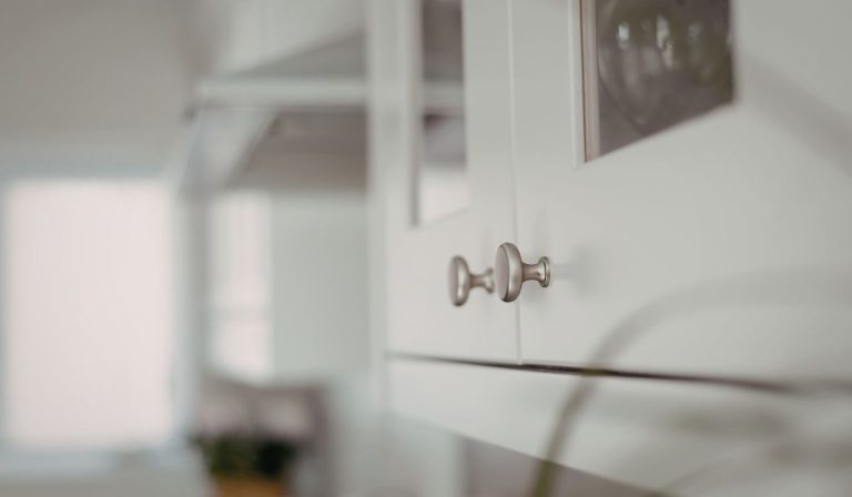 Freshly painted white kitchen cabinet door with brushed nickel hardware in a Sarasota home